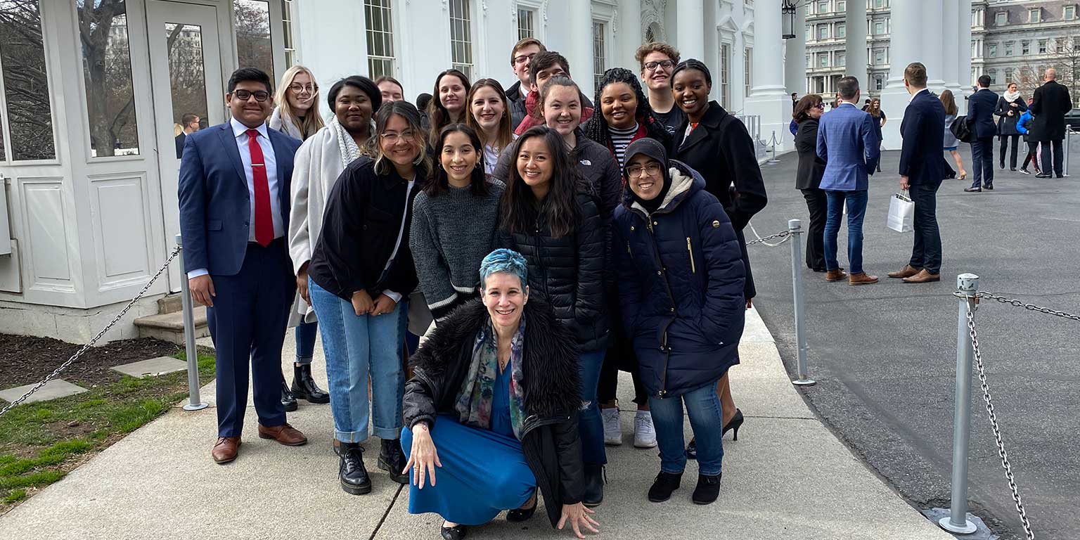 A group of Political Science students pose in front of the White House.